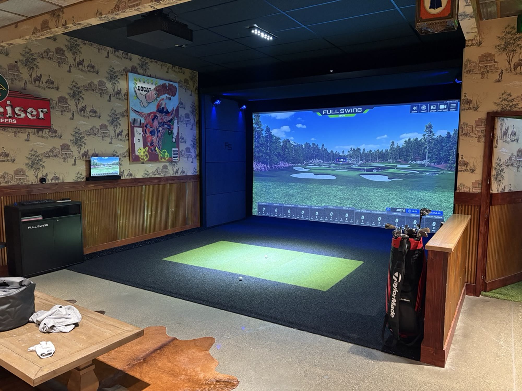 A Full Swing widescreen bay filling the end wall of an entertainment room